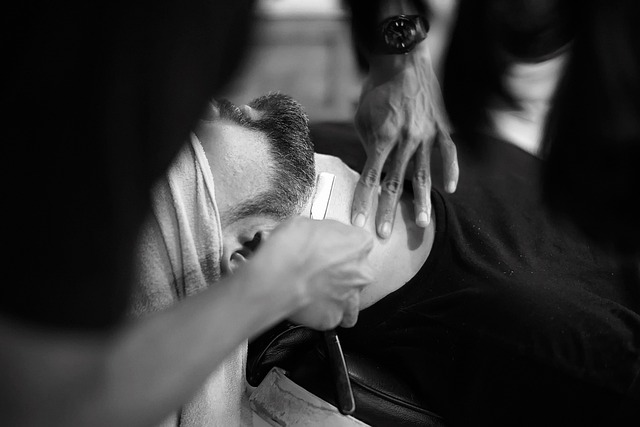 Barber giving a straight-razor shave in a small barbershop